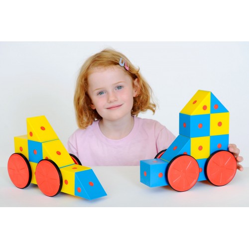 Colorful magnetic cube blocks on wagon-style wheels, with child holding assembled pieces