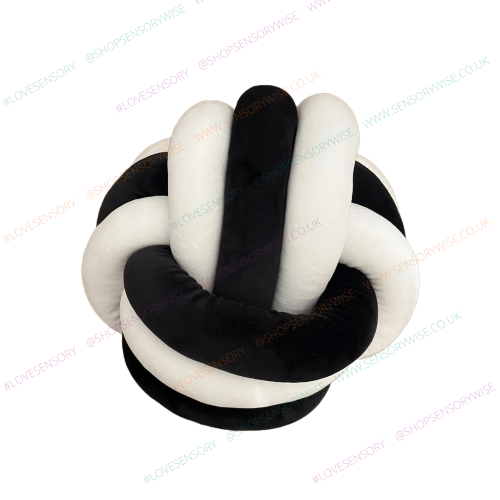 Black and white knot ball cuddle cushion with braided plush loop design