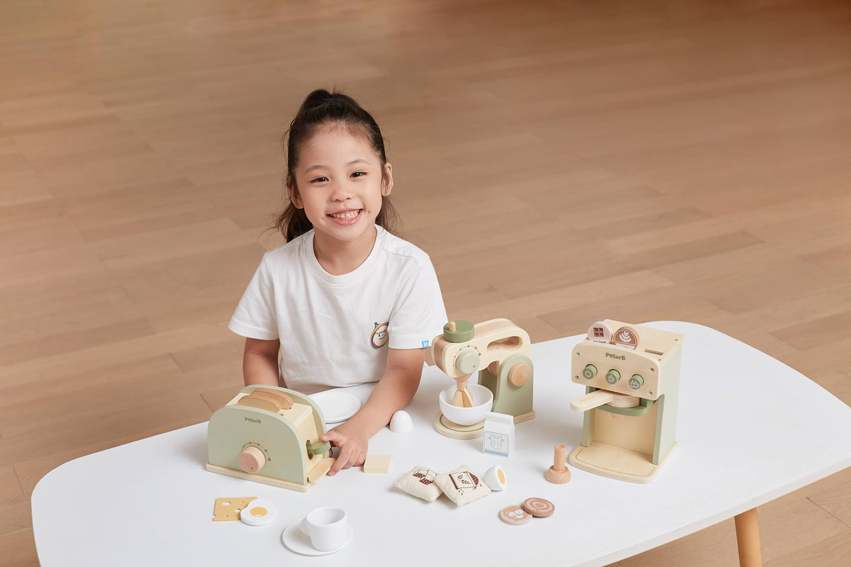 Wooden coffee machine play set on table with cups, pods, and accessories