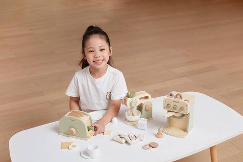 Wooden coffee machine play set on table with cups, pods, and accessories