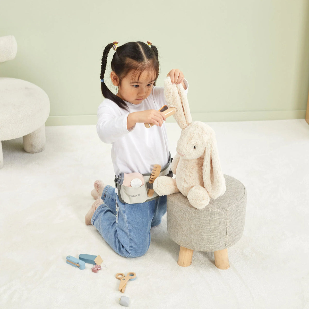 Children's hairdressing set with tool belt and accessories on a plush play doll