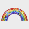 Colorful rainbow activity wall panel with interactive pieces on curved arch