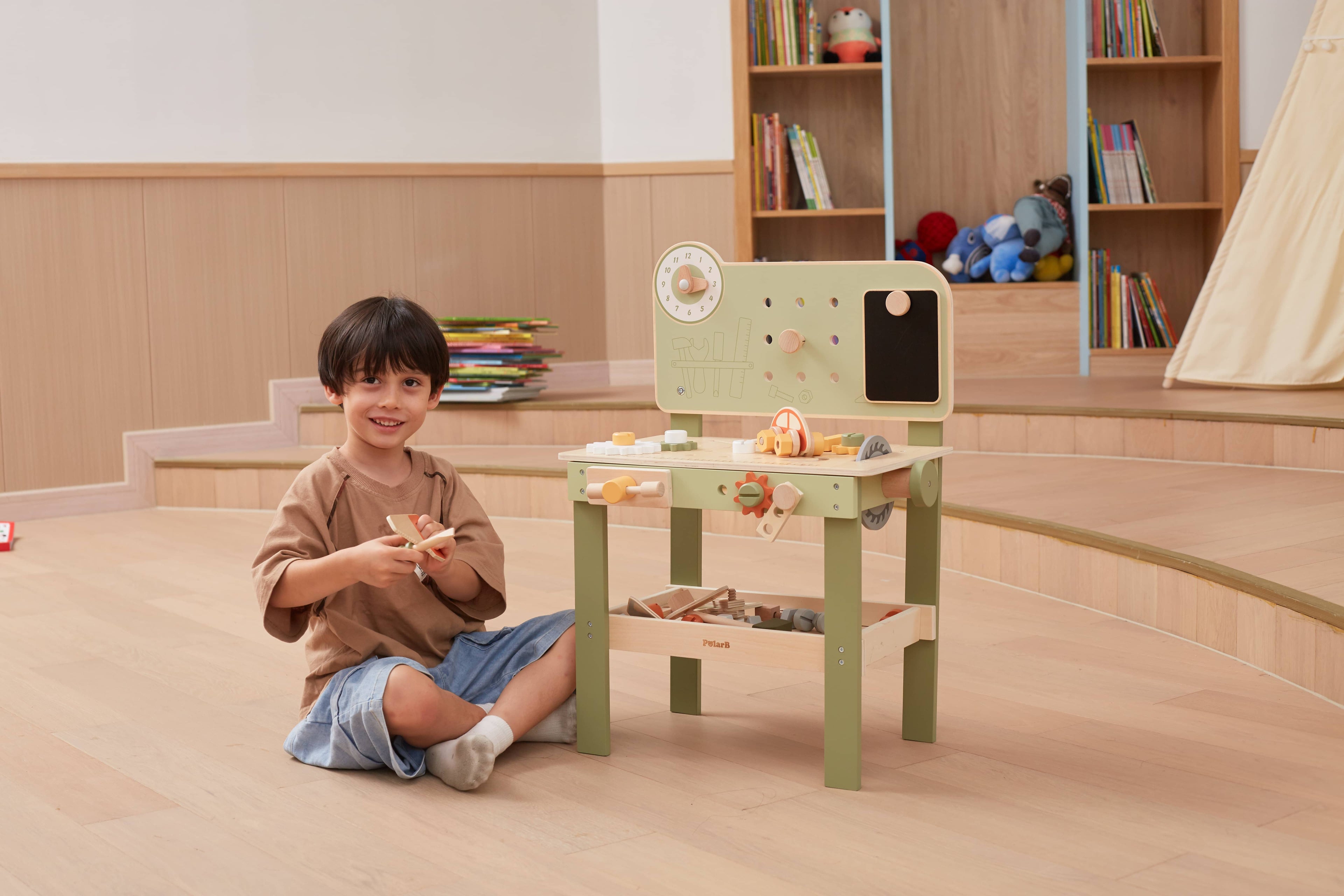 Kids wooden tool bench with tool panel and open storage shelf