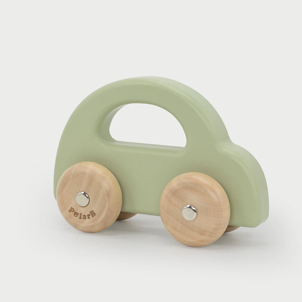 Green wooden toy car with cutout handle and two wooden wheels