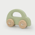 Green wooden toy car with cutout handle and two wooden wheels