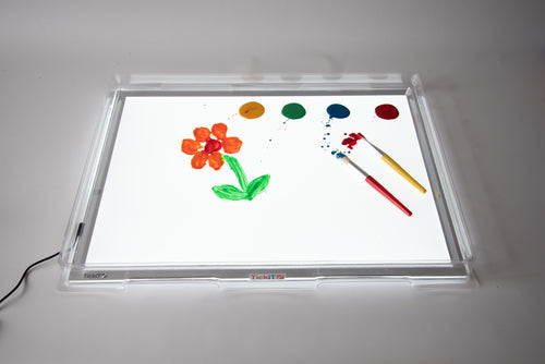 Light panel and cover showing colorful art pieces with paintbrushes on the tray