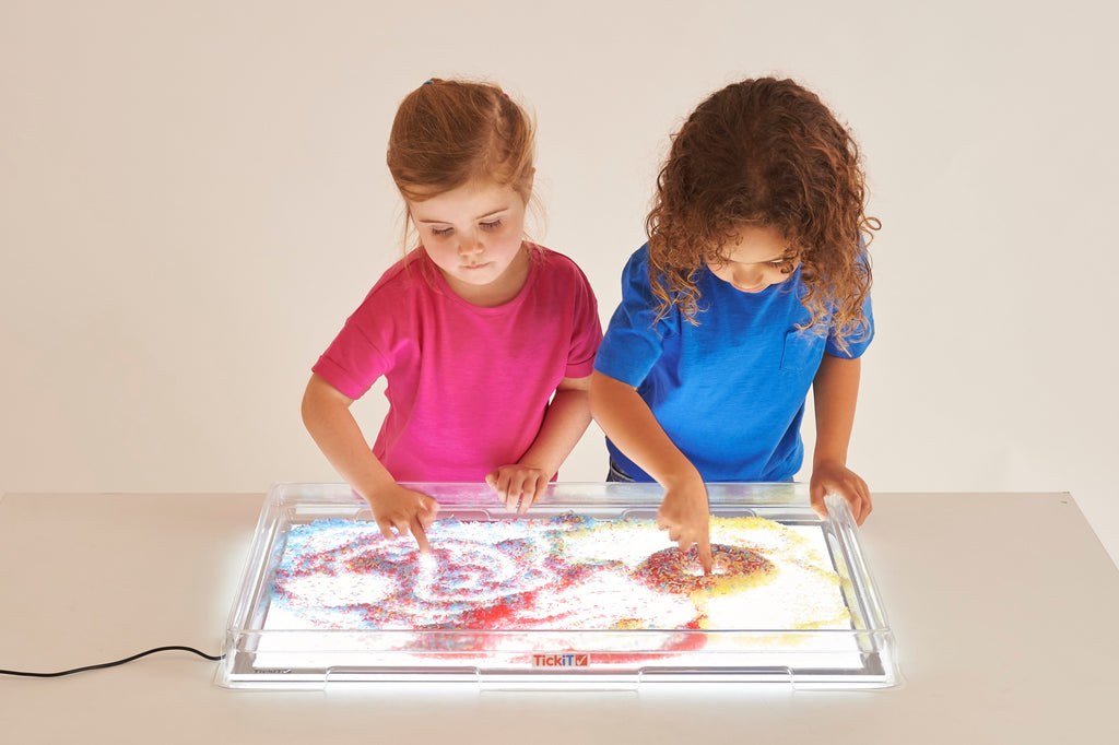 Light panel and cover with two children painting under the illuminated tray