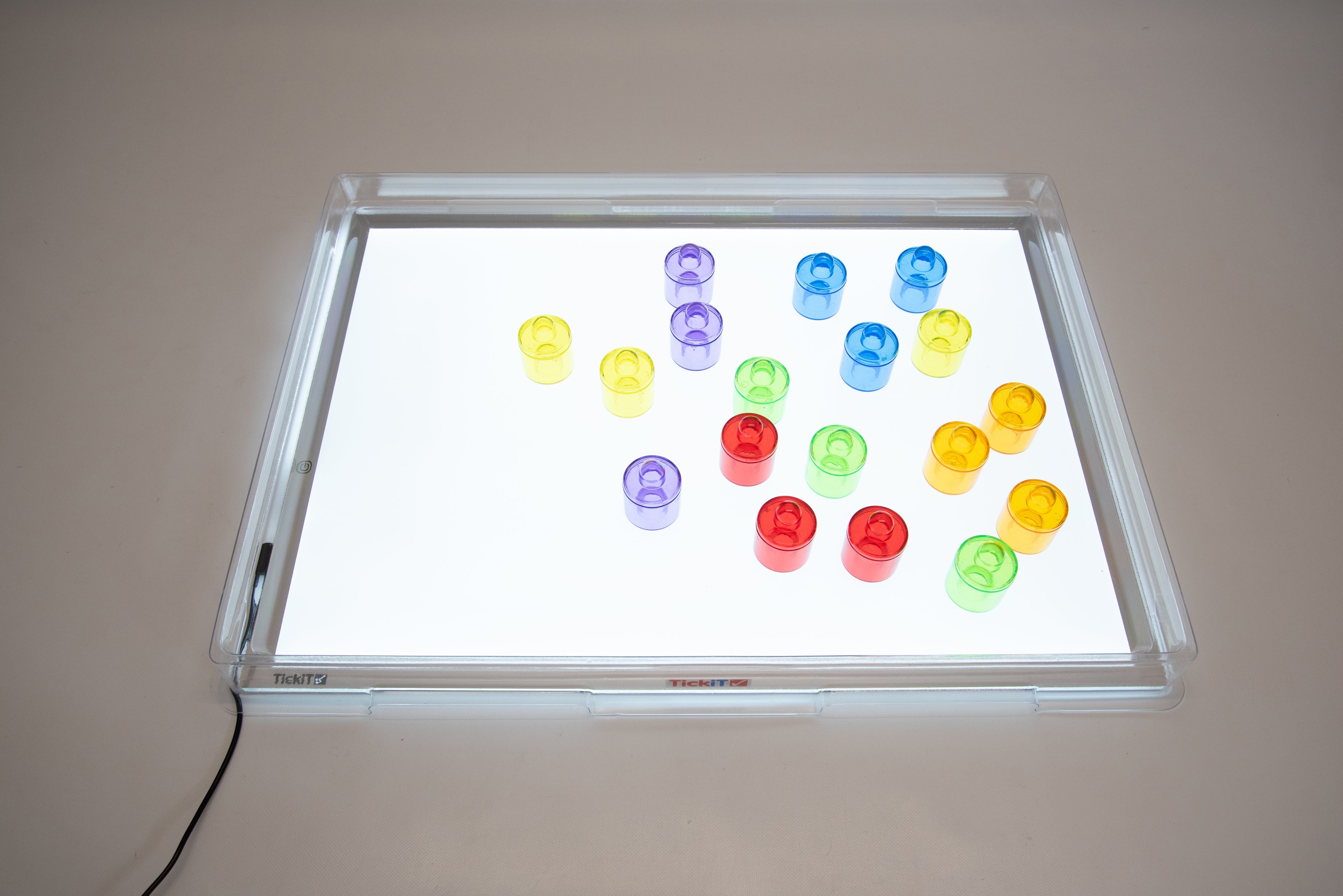Light panel and cover displaying multicolor translucent cup lights on tray