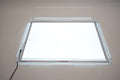 Light panel and cover with blank bright illumination inside the frame