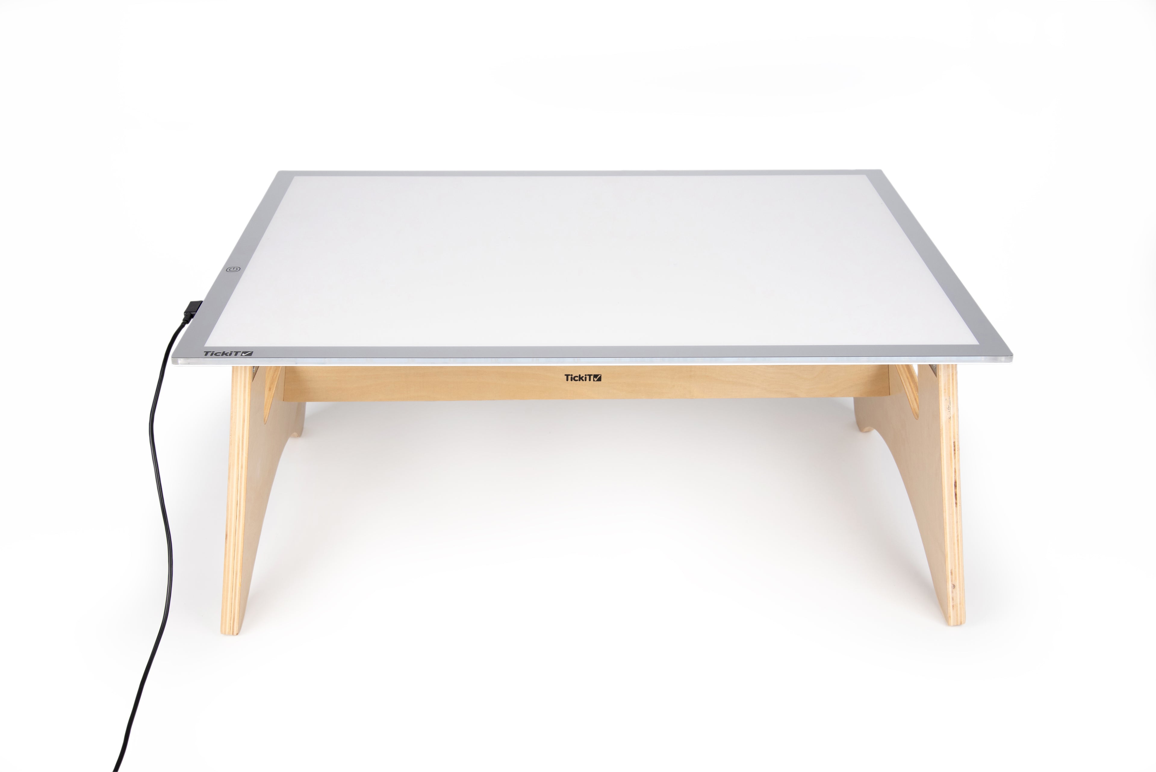 Light panel table set with white lit panel, light wood legs, and power cable