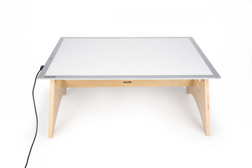 Light panel table set with white lit panel, light wood legs, and power cable