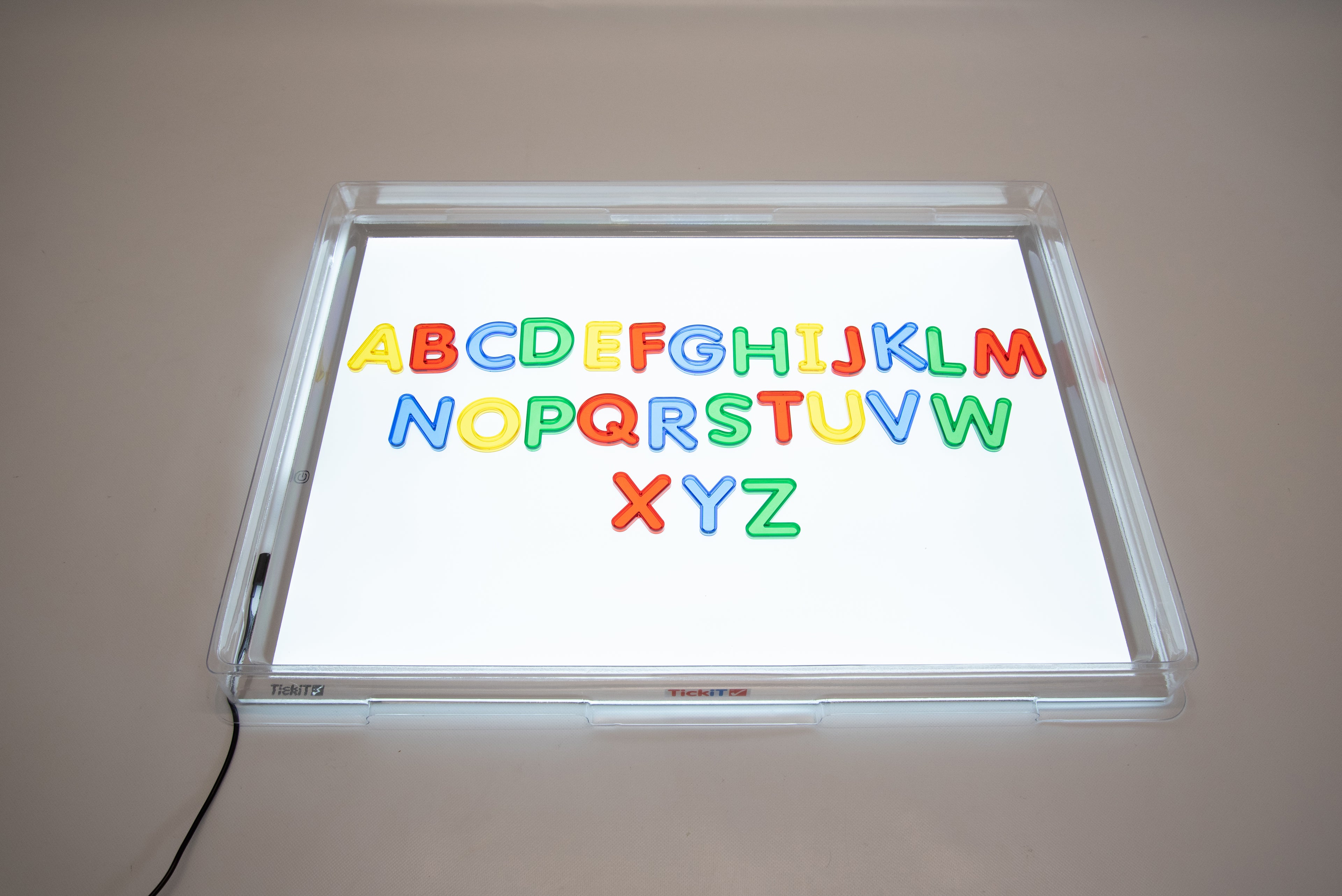 Transparent light panel cover with colorful alphabet letters displayed on the illuminated window