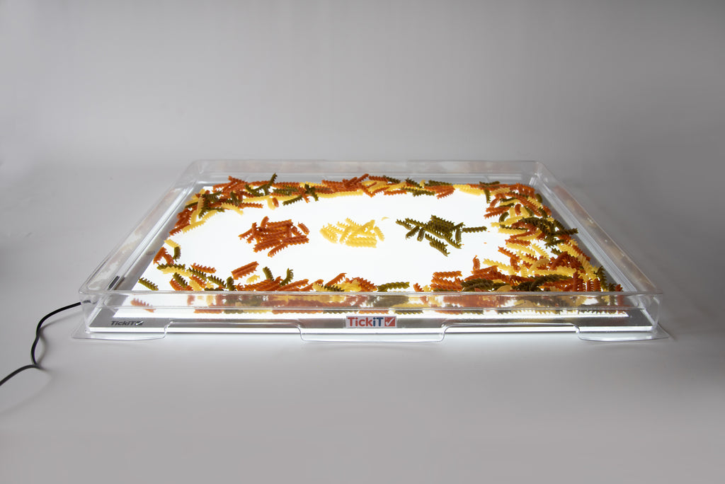 Transparent light panel cover with gold tinsel spread across the illuminated window