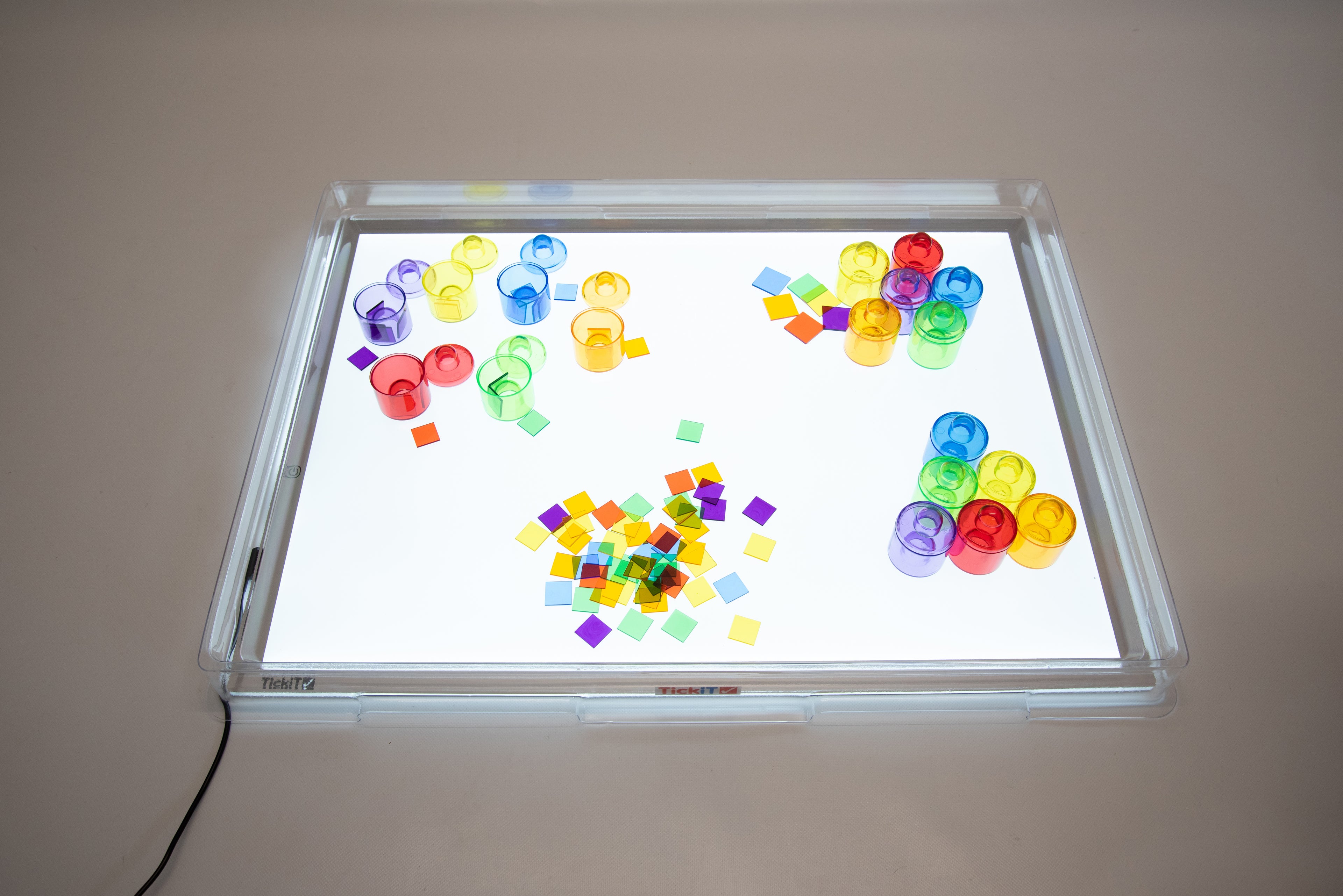 Transparent light panel cover showing colorful plastic blocks under the illuminated window