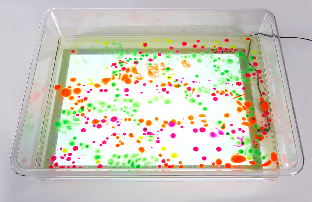 Clear light-up art tray with green and orange dot pattern