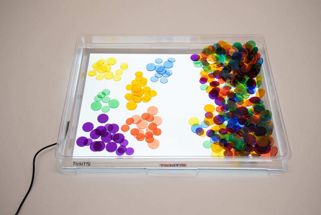 A3 light panel with cover, tray with colorful circular pieces arranged by color