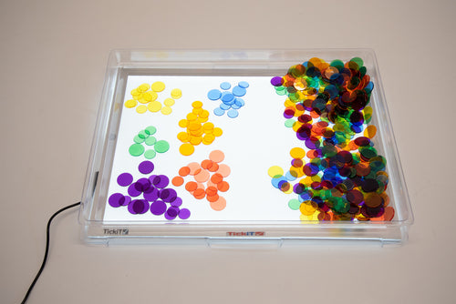 A3 light panel with cover, tray with colorful circular pieces arranged by color