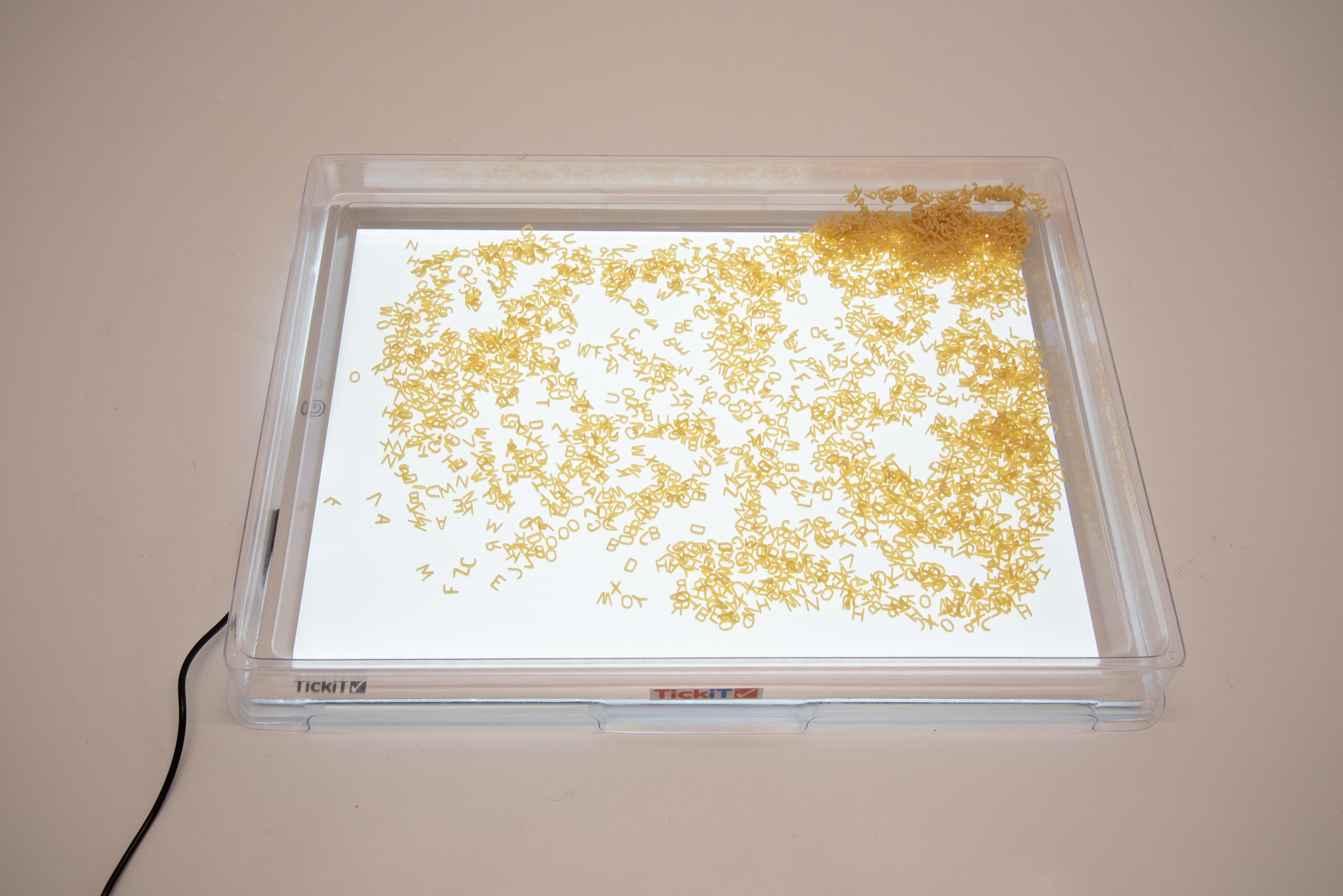 A3 light panel with cover, tray filled with golden confetti-like pieces