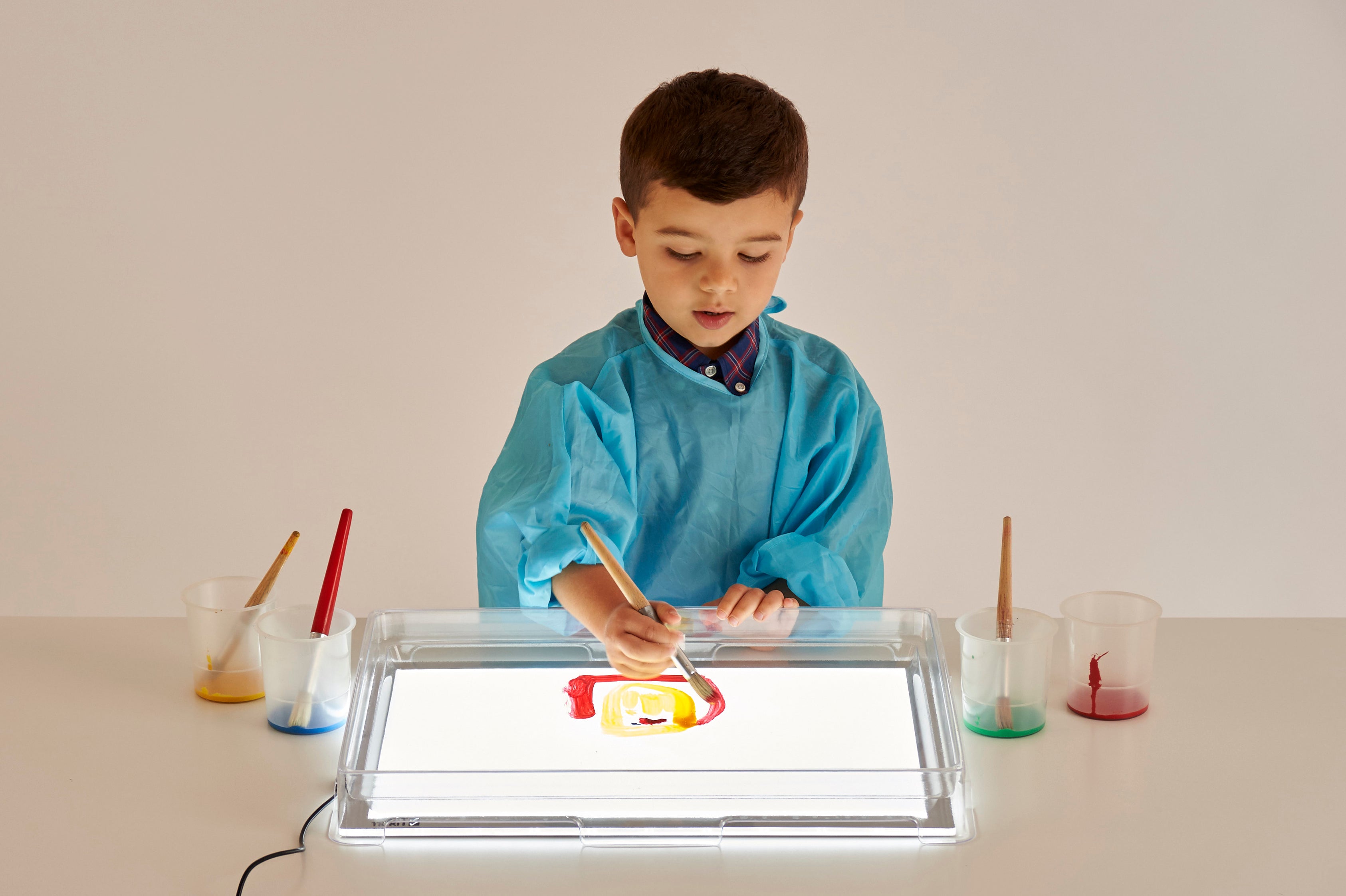 A3 light panel with cover, child using colored pieces on the lit acrylic surface