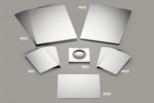 Assorted silver plastic mirror sheets with printed part numbers on them
