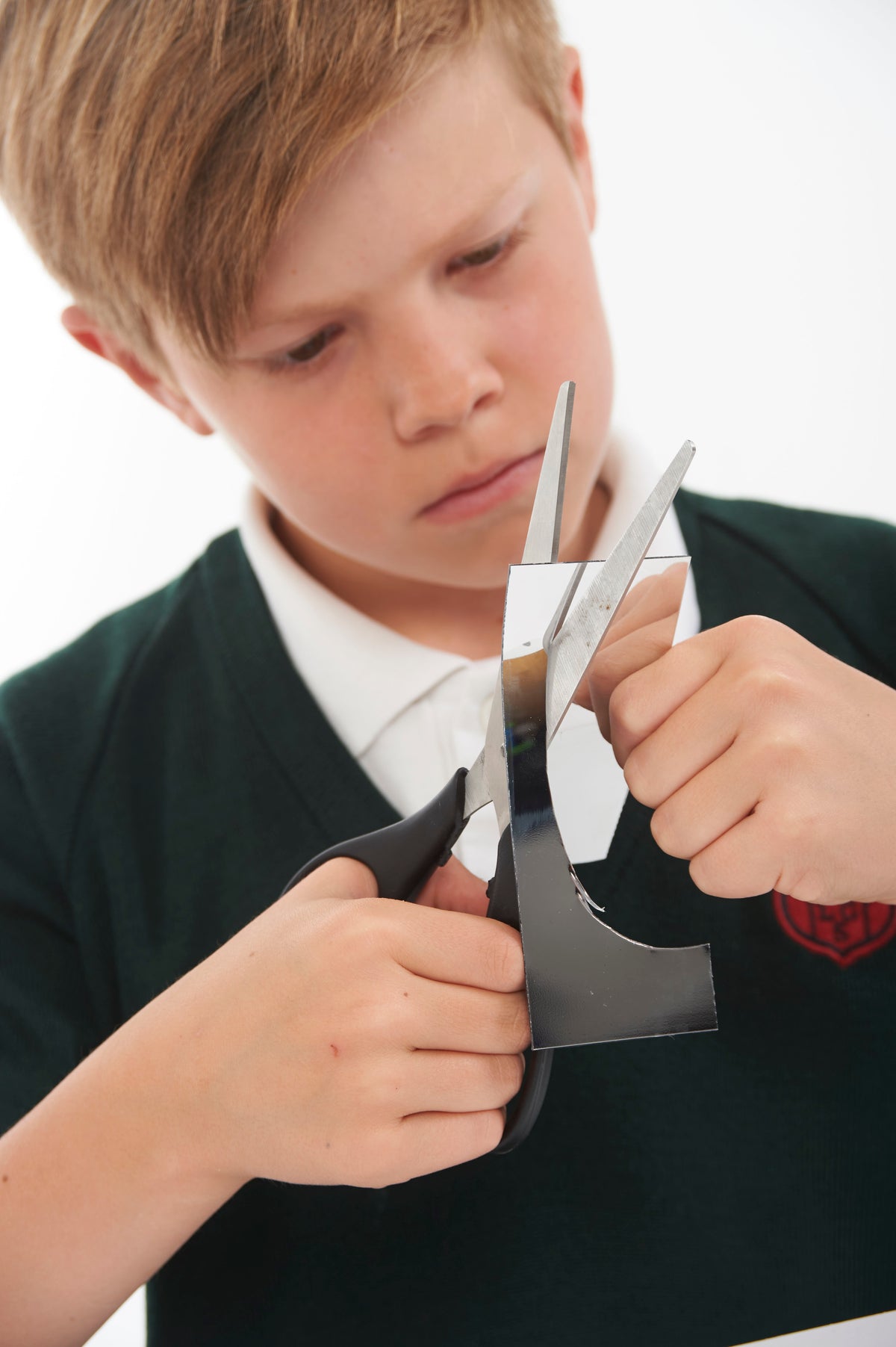 Silver plastic mirror strips held in hands, reflecting a face angle