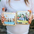 Acts of Kindness dice set showing photo quote faces, held in two hands