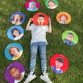 Round emotions face mats set, colorful cutouts surrounding a child standing outdoors