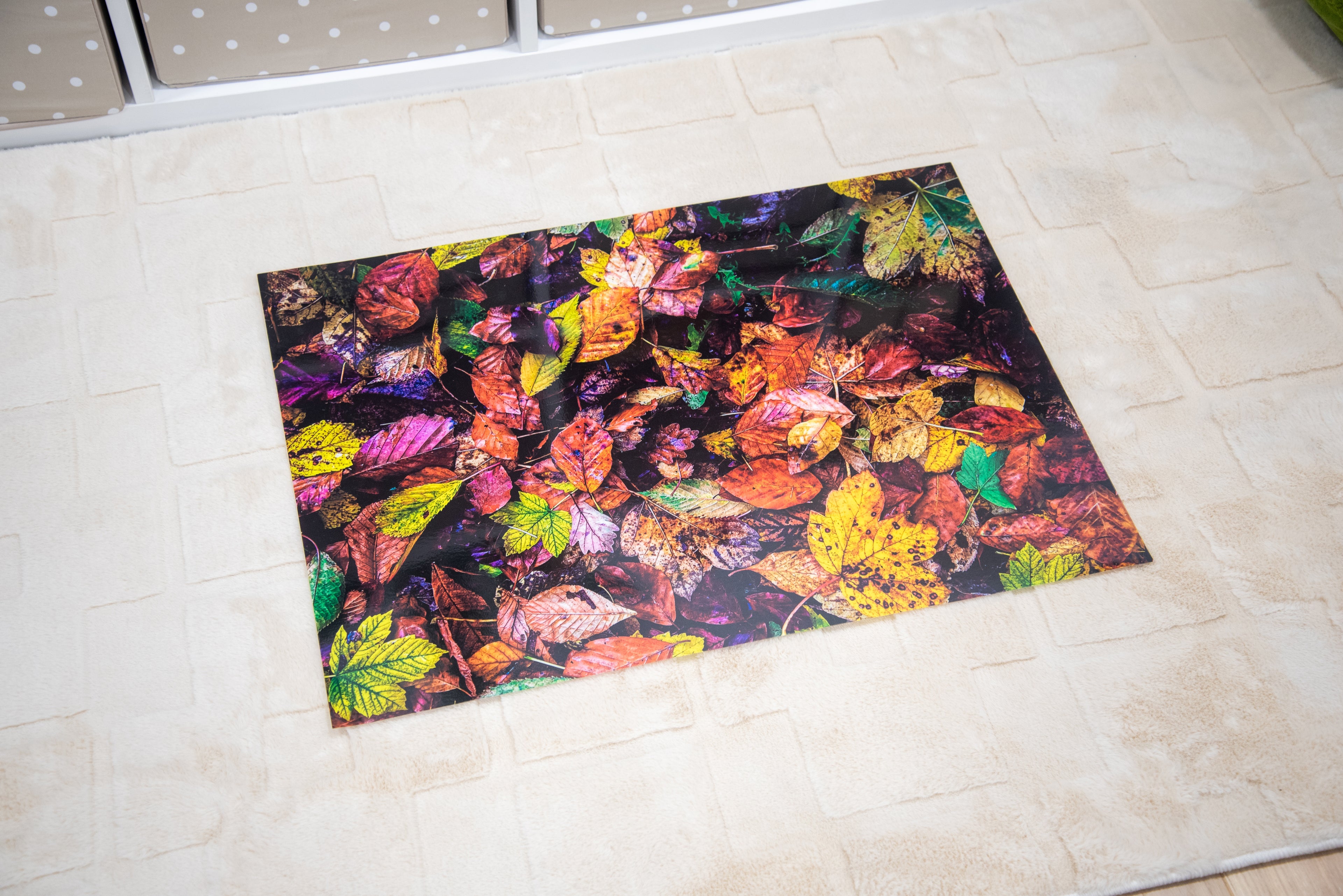 Rectangular play mat with vibrant autumn leaf collage artwork