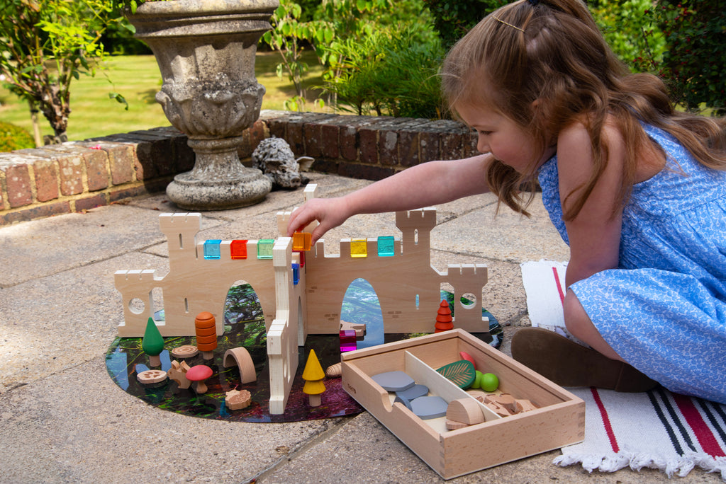 Castle divider playset with arched walls, toy animals, and compartment tray on a round mat