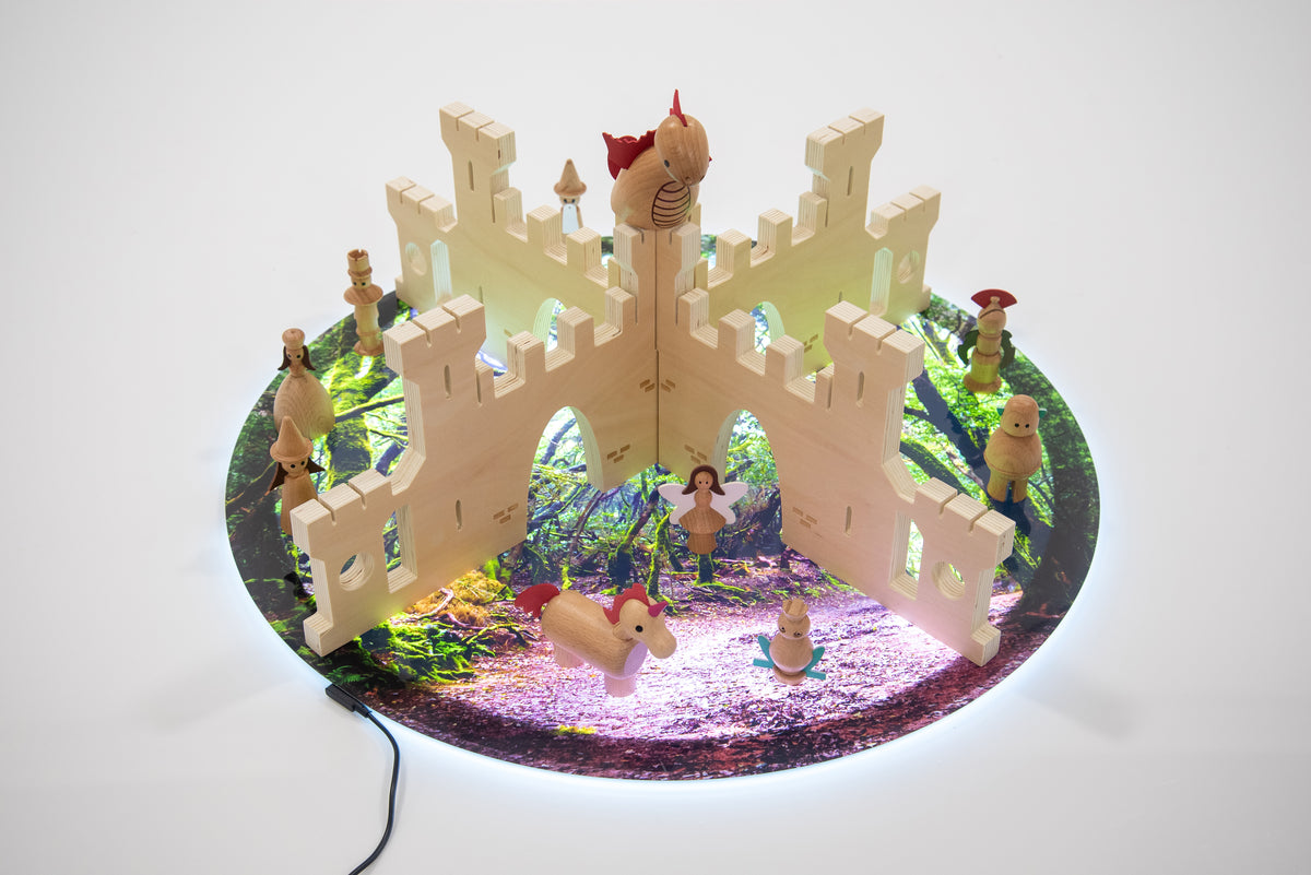 Castle divider playset with arched walls and toy figures on a round base with colorful details