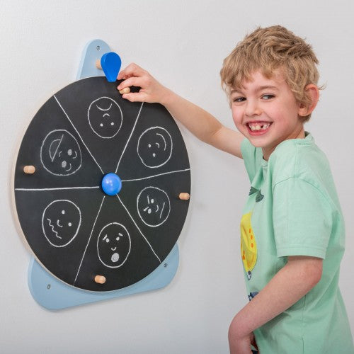 Chalkboard wall spinner with circular target face drawings and blue rotating pointer