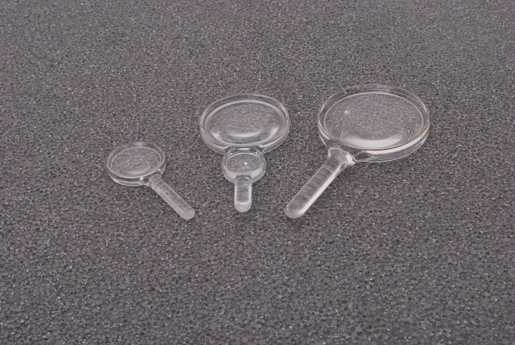 Set of clear plastic hand magnifiers with round lenses and short handles