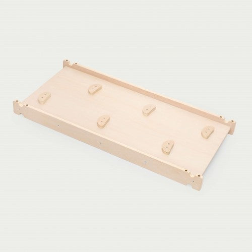 Wood climbing board with small handhold grips on top surface