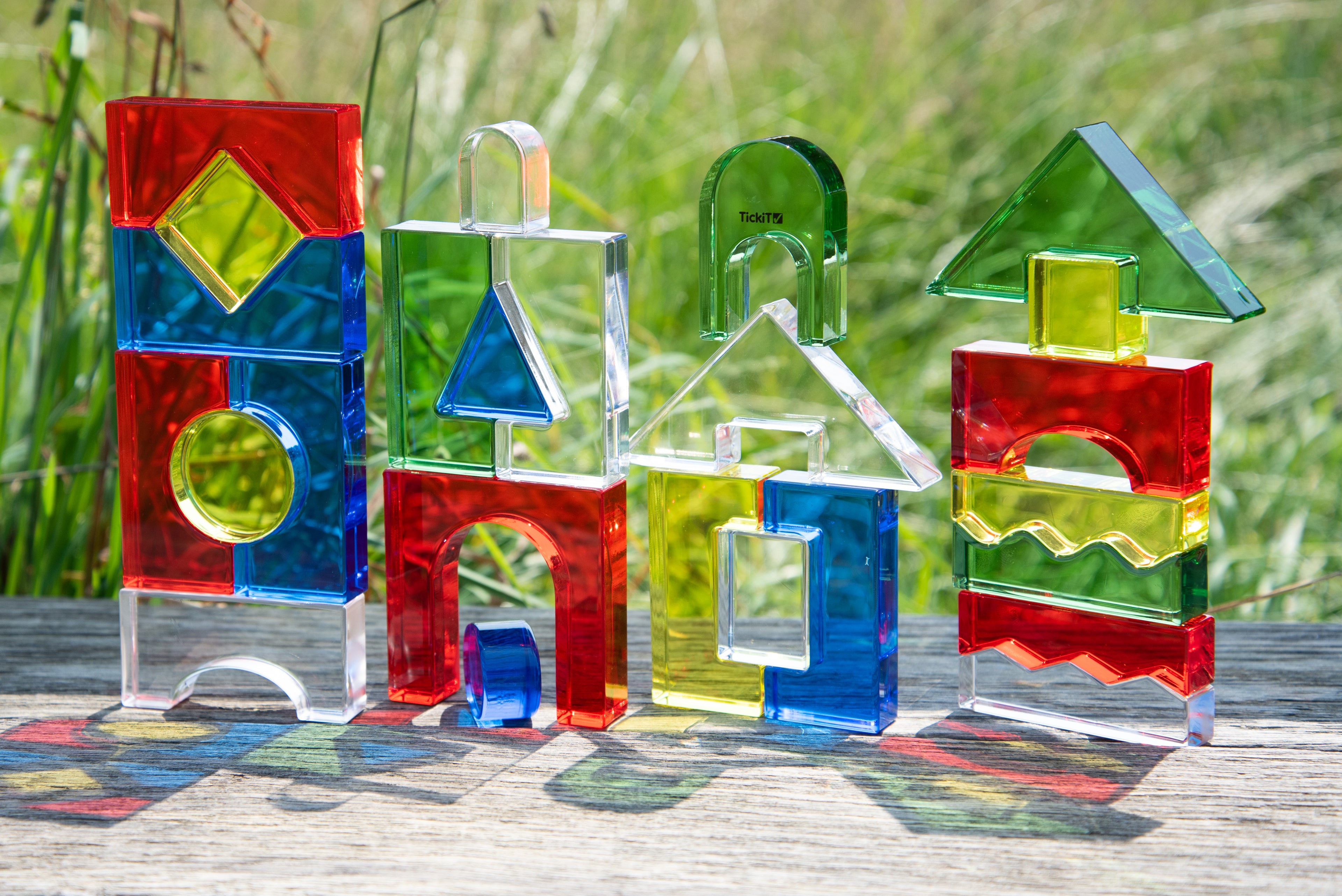 Outdoor display of colorful crystal building blocks in geometric shapes