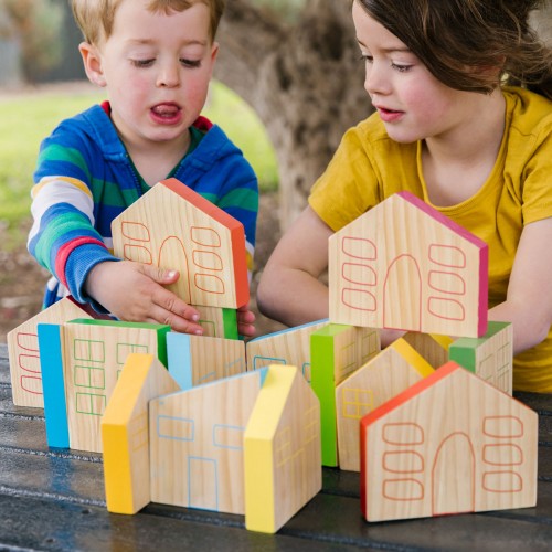 Multicolored wooden house-shaped blocks with cutout doors and windows