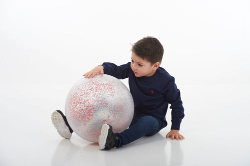 White inflatable confetti-speckled ball during kid play