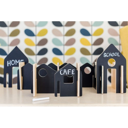 House-shaped building blocks, dark blue pieces labeled HOME, CAFE, SCHOOL