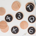 Wooden matching game cards with numerals 1-6 on black circles