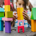 Colorful children's building blocks set with tall stacks and arched red base
