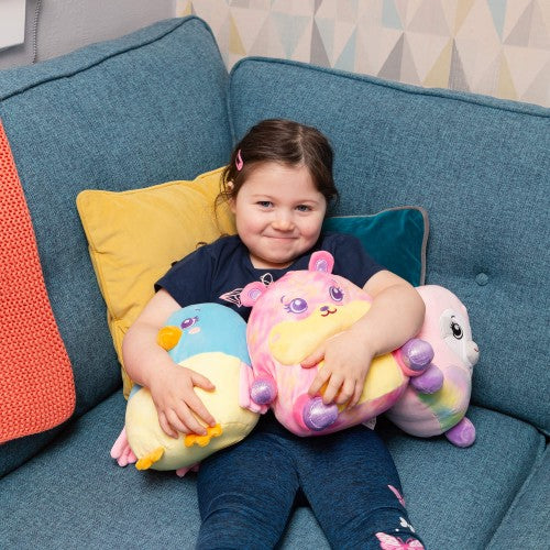 Multicolor plush animal toy with pink and purple accents, child holding on sofa