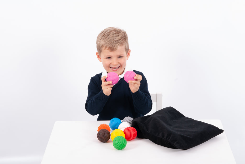Kids play ball set with colorful textured balls and black carrying pouch