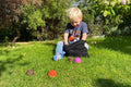 Kids activity ball set on grass: colorful textured balls with black pouch