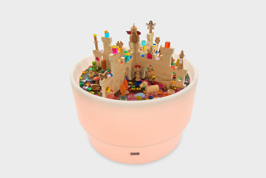 Pink illuminated discovery castle play table with colorful minifigures and buildings