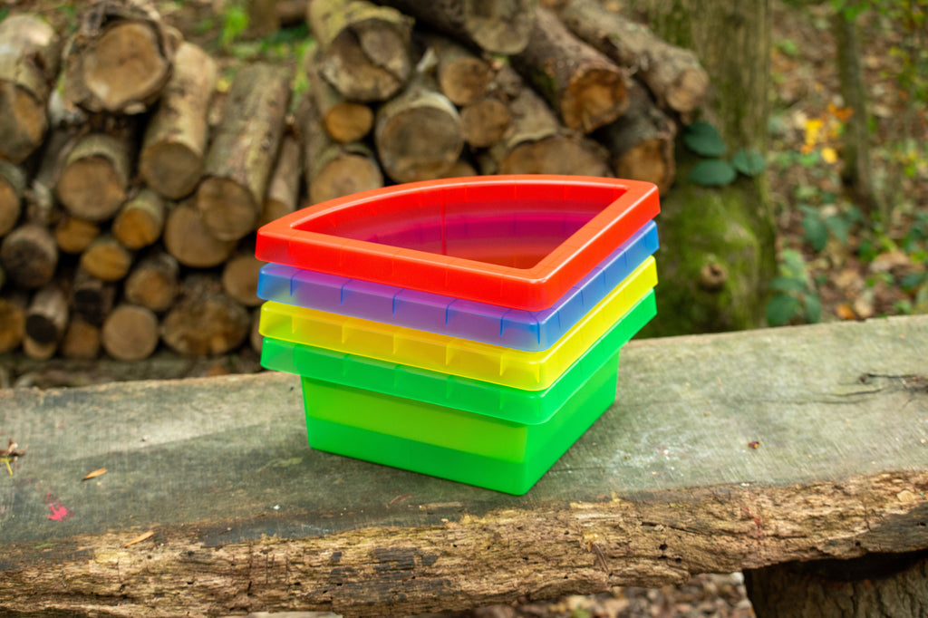 Four colorful quadrant trays stacked with translucent red, green, yellow and blue lids