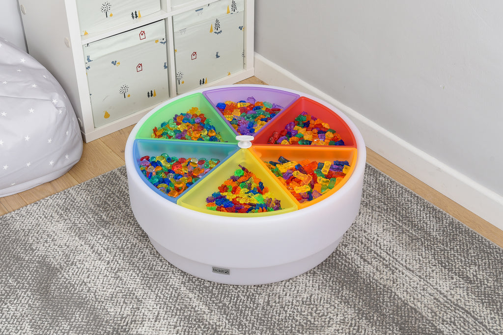 Round plastic color tray set with 6 rainbow compartments filled with colorful pieces