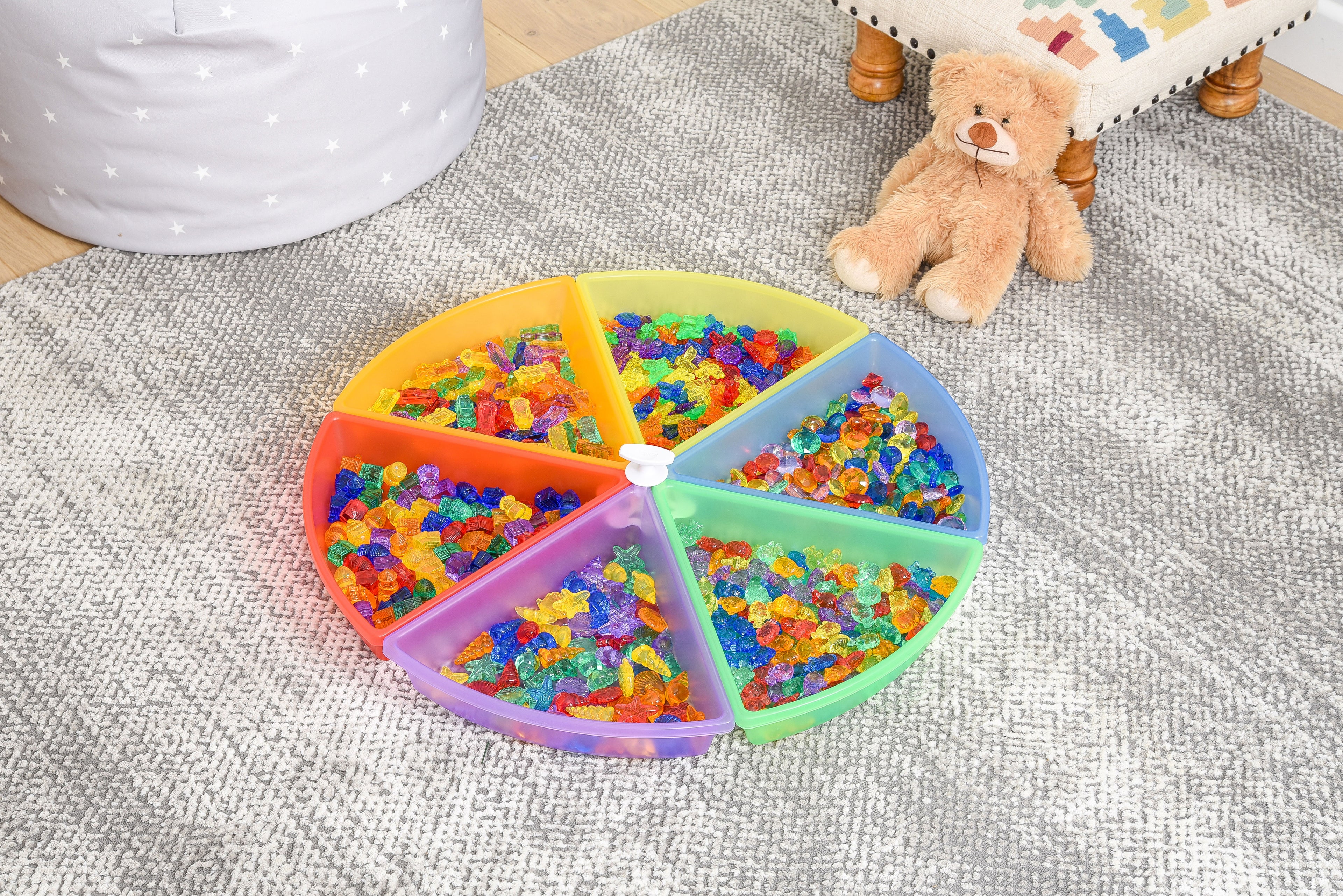 Round plastic color tray set with 6 rainbow compartments filled with colorful pieces