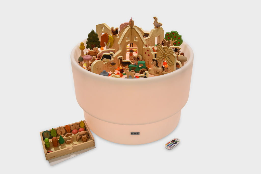 Pink round farm-themed playset container with miniature figures and accessory tray