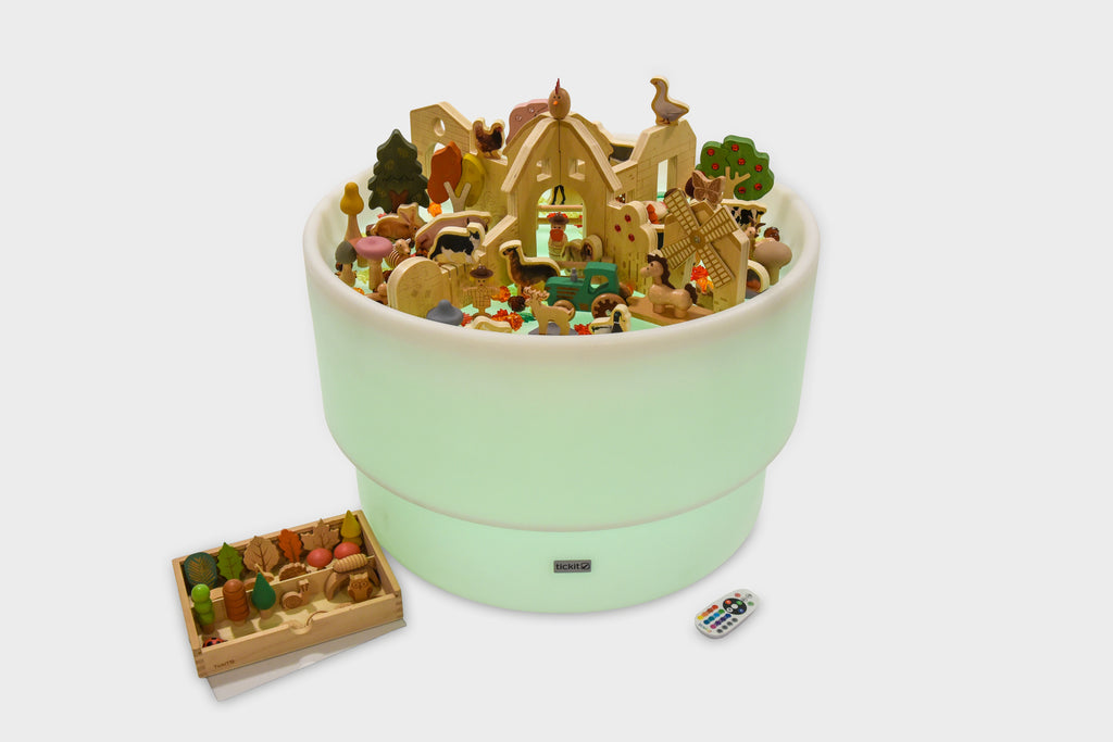 Green round farm-themed playset container with miniature figures and accessory tray