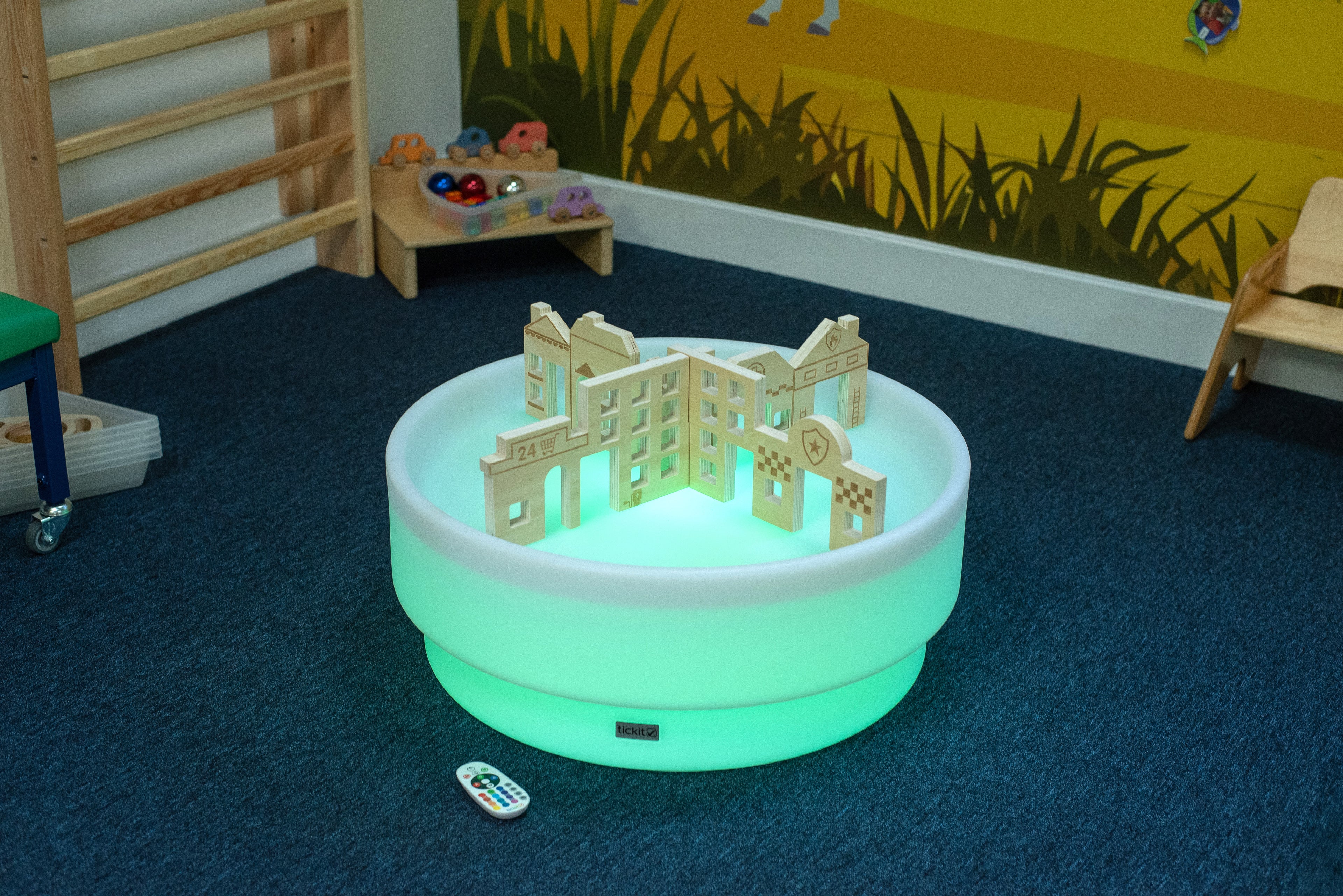 Glowing low table with building blocks inside and remote controller nearby