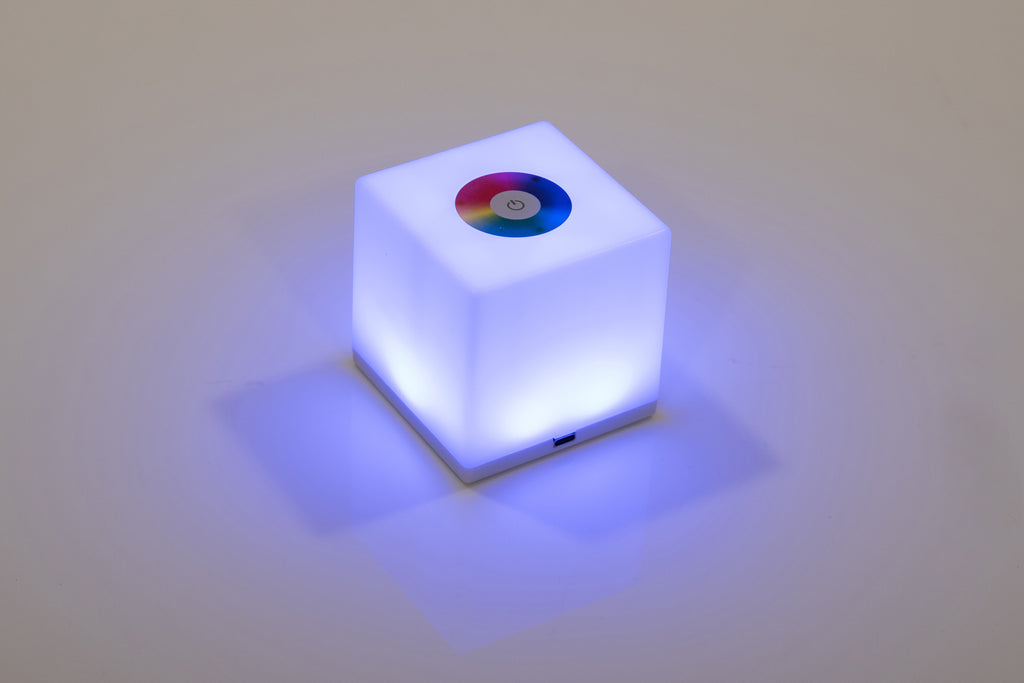 Mini cube LED lamp glowing purple with circular top lens